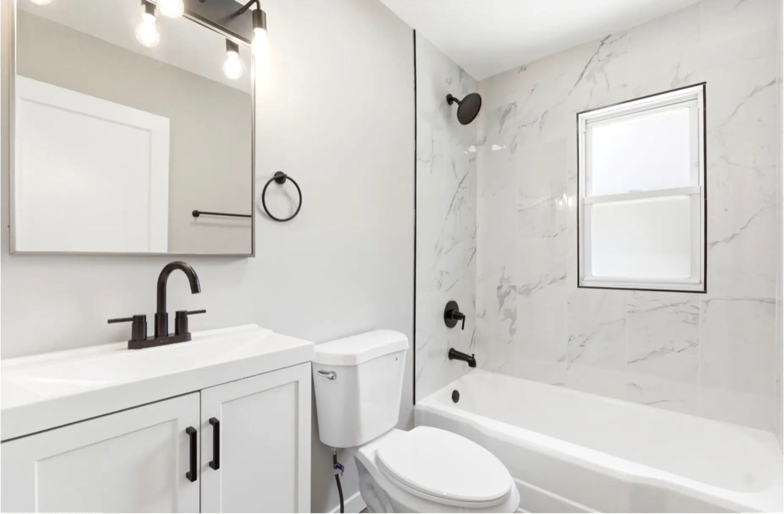 Bright White Bath with Marble Tub Surround