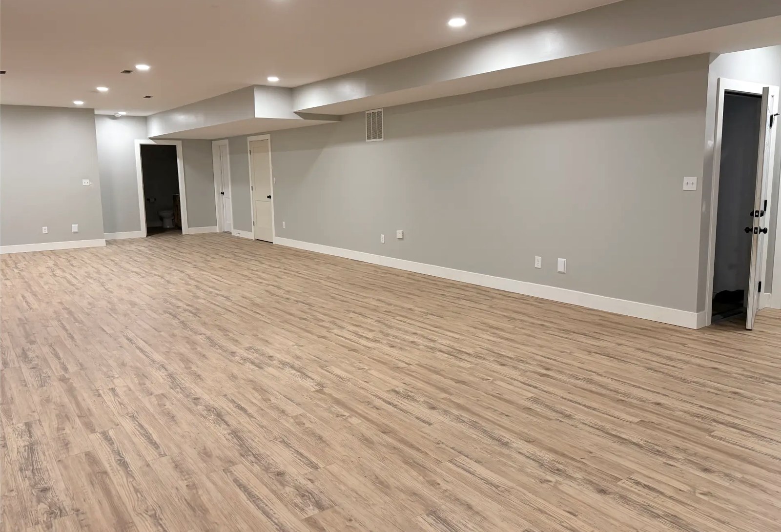Open Finished Basement with Vinyl Plank Flooring