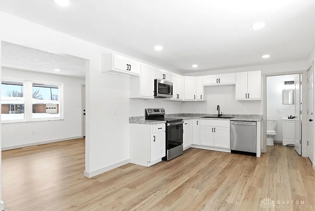 Open White Kitchen with Granite Counters