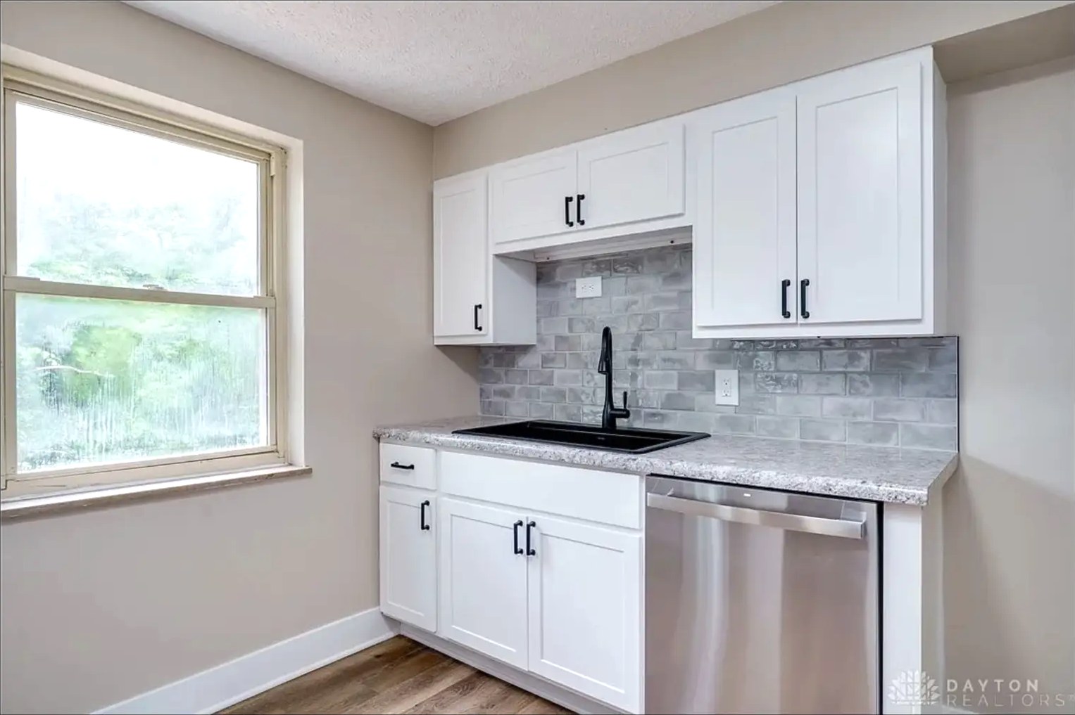 Compact Kitchen with Marble Tile Backsplash
